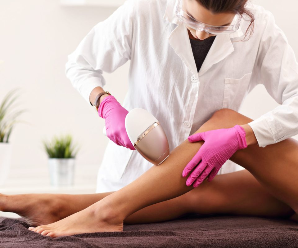 Adult woman having laser hair removal in professional beauty salon #image_title
