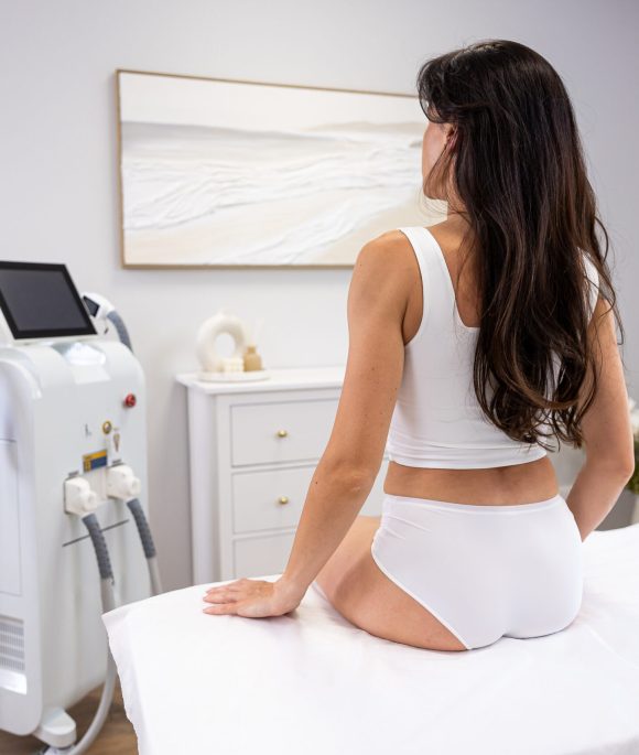 Woman preparing for laser hair removal treatment in a modern beauty clinic
